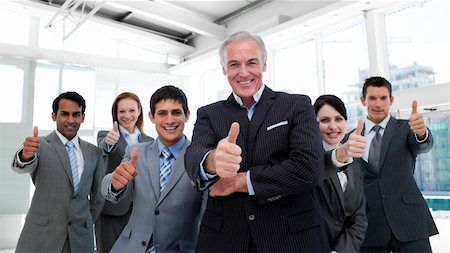 Happy multi-ethnic business team with thumbs up in the office Stock Photo - Budget Royalty-Free & Subscription, Code: 400-04662162