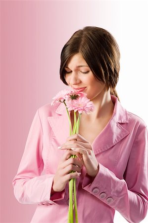 simsearch:400-04667271,k - cute young brunette smelling pink flowers and making funny face Stock Photo - Budget Royalty-Free & Subscription, Code: 400-04662575