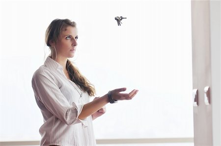 happy young woman throw keys from their apartment and home in ai and representing concept of joy and financial freedom Stock Photo - Budget Royalty-Free & Subscription, Code: 400-04663994