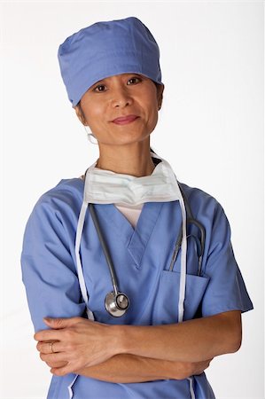 edbockstock (artist) - Portrait of an Asian female medical professional wearing scrubs. She is looking at the camera and has her arms crossed. Vertical shot. Isolated on white. Photographie de stock - Aubaine LD & Abonnement, Code: 400-04674106