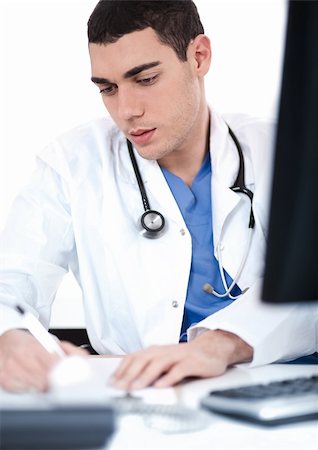 Handsome doctor making notes from the computer at his desk Stock Photo - Budget Royalty-Free & Subscription, Code: 400-04674577