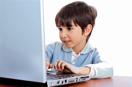 simsearch:400-04622918,k - Cute caucasian kid working in laptop on isolated white background Stock Photo - Budget Royalty-Free & Subscription, Code: 400-04674669