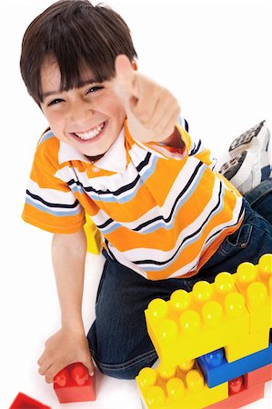plastic toy family - Boy shows ok sign when playing over white background Stock Photo - Budget Royalty-Free & Subscription, Code: 400-04674679