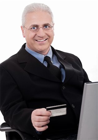 simsearch:400-03972352,k - Senior business man making online purchase with his credit card on white background Stock Photo - Budget Royalty-Free & Subscription, Code: 400-04674827