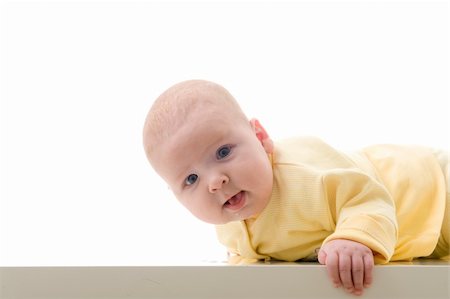 simsearch:400-05727835,k - Young baby boy creeps on a table, over white background Fotografie stock - Microstock e Abbonamento, Codice: 400-04675239