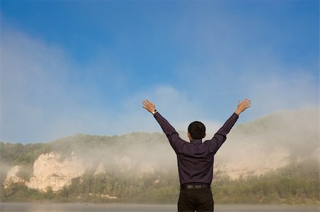 simsearch:400-04982004,k - The man feels freedom. Over blue sky and mountains Stock Photo - Budget Royalty-Free & Subscription, Code: 400-04675233
