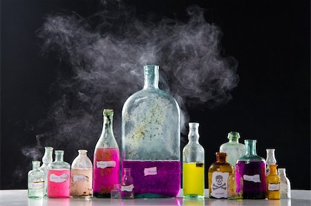 Magic spells in antique bottles over black background and smoke Stock Photo - Budget Royalty-Free & Subscription, Code: 400-04675463