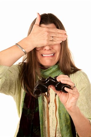 simsearch:640-01358369,k - Adult woman covering her eyes after using binoculars Photographie de stock - Aubaine LD & Abonnement, Code: 400-04675919