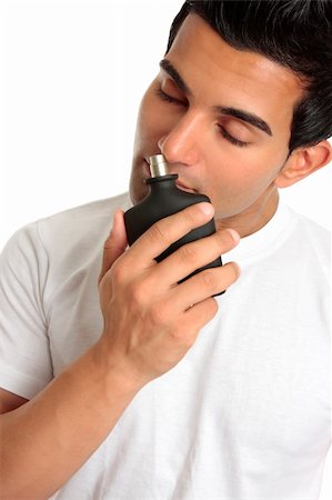 A man samples the smell of a bottle of aftershave cologne perfume. Stock Photo - Budget Royalty-Free & Subscription, Code: 400-04676011