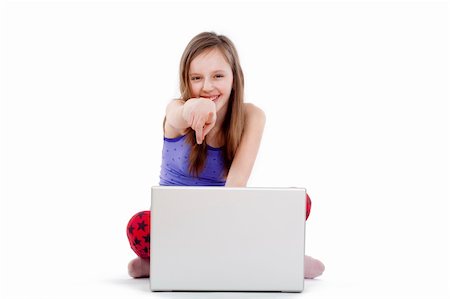 preteens fingering - girl sitting on the floor with laptop pointing at camera smiling Stock Photo - Budget Royalty-Free & Subscription, Code: 400-04676262