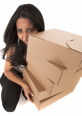 Young adult African-Indian businesswoman in casual office outfit carrying brown cardboard boxes on a white background. Not Isolated Stock Photo - Budget Royalty-Free & Subscription, Code: 400-04676449