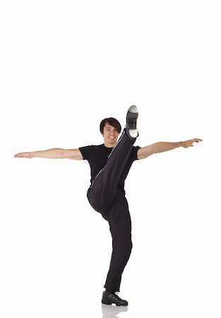 Single Caucasian male tap dancer wearing black pants showing various steps in studio with white background and reflective floor. Not isolated Stock Photo - Budget Royalty-Free & Subscription, Code: 400-04676611