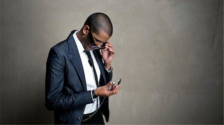 Man looks to his watch for a time update Stock Photo - Budget Royalty-Free & Subscription, Code: 400-04676853