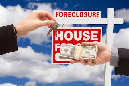 eviction - Handing Over Cash For House Keys in Front of Foreclosure Sign and Cloudy Blue Sky. Stock Photo - Budget Royalty-Free & Subscription, Code: 400-04677270
