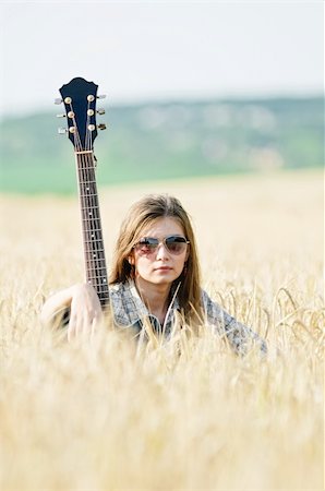 shivanetua (artist) - Rocking girl on a nature with guitar Fotografie stock - Microstock e Abbonamento, Codice: 400-04677303