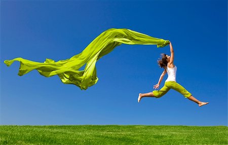 simsearch:400-06077546,k - Beautiful young woman jumping on  a green meadow with a colored tissue Stockbilder - Microstock & Abonnement, Bildnummer: 400-04677429