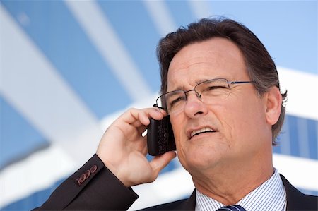 simsearch:400-04608943,k - Confident, Handsome Businessman Smiles as He Talks on His Cell Phone. Stock Photo - Budget Royalty-Free & Subscription, Code: 400-04677904