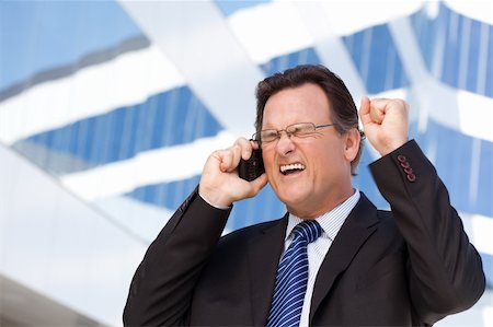 simsearch:400-04164036,k - Excited Businessman Using Cell Phone Clinches His Fist in Joy Outside of Corporate Building. Foto de stock - Super Valor sin royalties y Suscripción, Código: 400-04677908
