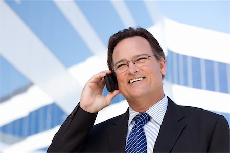 simsearch:400-04608943,k - Confident, Handsome Businessman Smiles as He Talks on His Cell Phone. Stock Photo - Budget Royalty-Free & Subscription, Code: 400-04677902