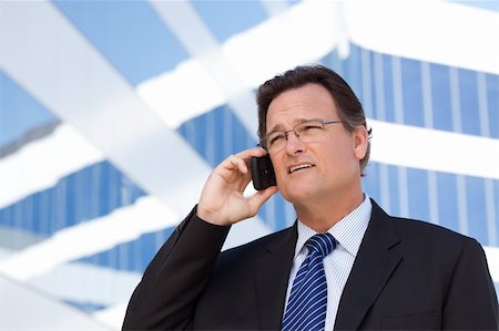 simsearch:400-04608943,k - Confident, Handsome Businessman Smiles as He Talks on His Cell Phone. Stock Photo - Budget Royalty-Free & Subscription, Code: 400-04677903