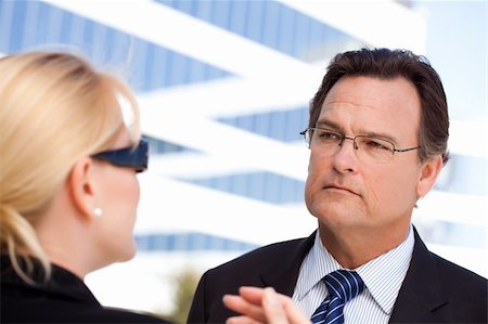 female manager talking to concerned employee - Attentive Handsome Businessman in Suit and Tie Listens to Female Colleague Outdoors. Stock Photo - Budget Royalty-Free & Subscription, Code: 400-04677916