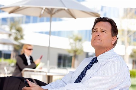 simsearch:400-04963726,k - Handsome Businessman in Necktie Looks Off Into the Distance During a Break Outdoors. Stock Photo - Budget Royalty-Free & Subscription, Code: 400-04677917