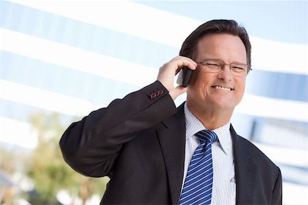 simsearch:400-04608943,k - Confident, Handsome Businessman Smiles as He Talks on His Cell Phone. Stock Photo - Budget Royalty-Free & Subscription, Code: 400-04677913