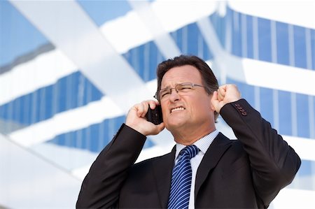 simsearch:400-04164036,k - Excited Businessman Using Cell Phone Clinches His Fist in Joy Outside of Corporate Building. Foto de stock - Super Valor sin royalties y Suscripción, Código: 400-04678368