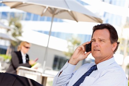 simsearch:400-04608943,k - Confident, Handsome Businessman Smiles as He Talks on His Cell Phone. Stock Photo - Budget Royalty-Free & Subscription, Code: 400-04678376