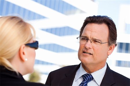female manager talking to concerned employee - Attentive, Handsome Businessman in Suit and Tie Talking with Female Colleague Outdoors. Stock Photo - Budget Royalty-Free & Subscription, Code: 400-04678372
