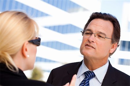 female manager talking to concerned employee - Attentive, Handsome Businessman in Suit and Tie Talking with Female Colleague Outdoors. Stock Photo - Budget Royalty-Free & Subscription, Code: 400-04678373