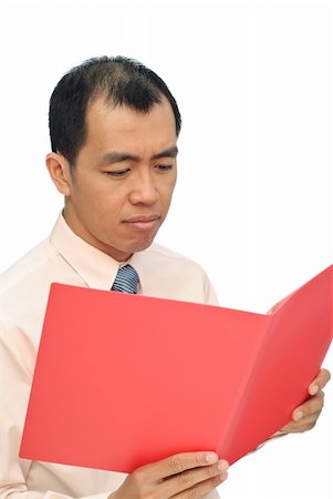 Sad businessman of Asian reviewing report on red folder with sorrowful expression on white background. Stock Photo - Budget Royalty-Free & Subscription, Code: 400-04678713