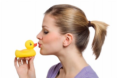 young woman kissing the yellow rubber duck on her hand Stock Photo - Budget Royalty-Free & Subscription, Code: 400-04670024
