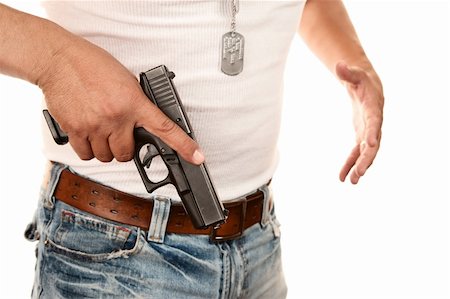 Closeup of man in t-shirt drawing gun from waist Stock Photo - Budget Royalty-Free & Subscription, Code: 400-04670551