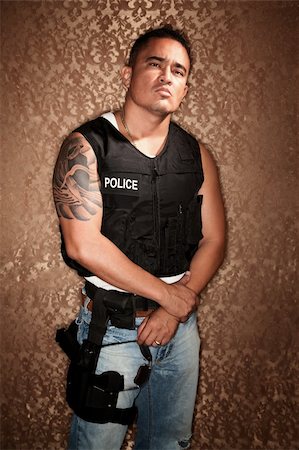 simsearch:400-04172754,k - Police Officer with Bulletproff Vest on Gold Background Stock Photo - Budget Royalty-Free & Subscription, Code: 400-04670587