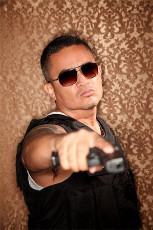 simsearch:400-04670594,k - Hispanic Cop Pointing Gun at Camera Gangster Style Foto de stock - Super Valor sin royalties y Suscripción, Código: 400-04670590