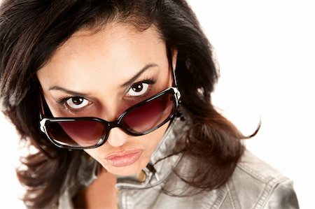 Pretty Latina Woman Looking Over the Top of Her Glasses Foto de stock - Super Valor sin royalties y Suscripción, Código: 400-04670611