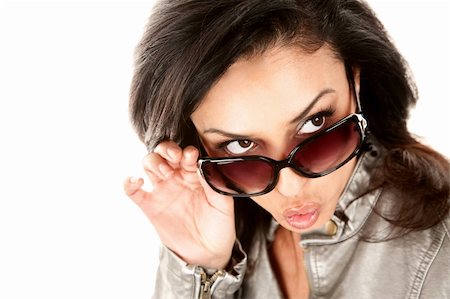 Pretty Hispanic woman looking over her glasses and whistling Stock Photo - Budget Royalty-Free & Subscription, Code: 400-04671079