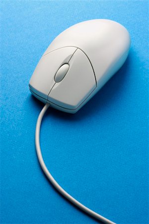 simsearch:640-02776186,k - Computer mouse on a blue surface. Vertical shot. Fotografie stock - Microstock e Abbonamento, Codice: 400-04671898