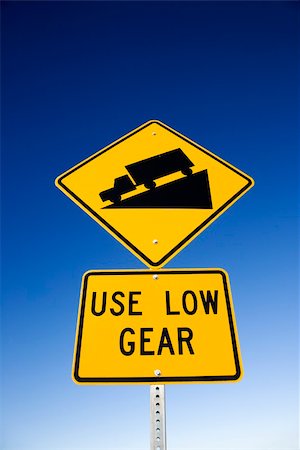 steep grade - 'Use low gear' and steep grade warning signs. Vertical shot. Stock Photo - Budget Royalty-Free & Subscription, Code: 400-04671893