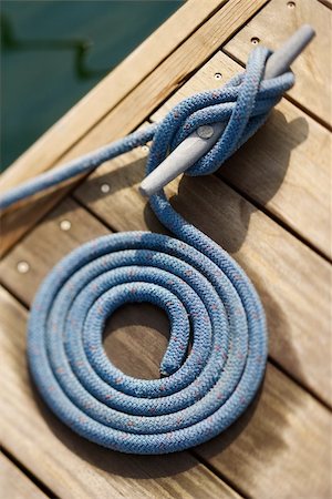 rope coil - Coiled rope tied to docking cleat. Vertically framed shot. Stock Photo - Budget Royalty-Free & Subscription, Code: 400-04671988