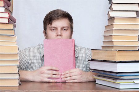 Young student sitting with book and thinking Photographie de stock - Aubaine LD & Abonnement, Code: 400-04672245