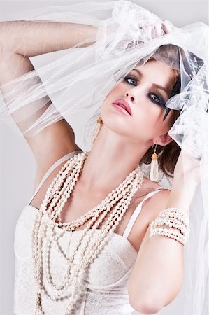 simsearch:400-04672924,k - Attractive young woman wearing a veil, a pearl necklace and a bracelet. Vertical shot. Photographie de stock - Aubaine LD & Abonnement, Code: 400-04672918