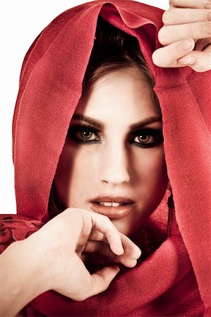 simsearch:400-04672924,k - Attractive young woman with her hands to her face and wearing a red shawl. Vertical shot. Photographie de stock - Aubaine LD & Abonnement, Code: 400-04672913