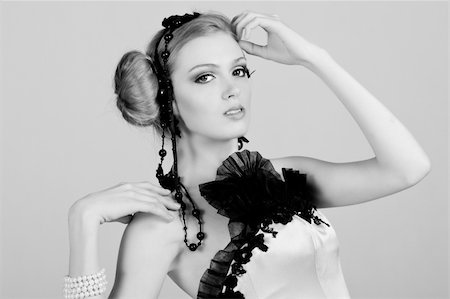 simsearch:400-04672924,k - Attractive young woman wearing black feather and pearl hair dressings. She has her hand on her head. Horizontal shot. Photographie de stock - Aubaine LD & Abonnement, Code: 400-04672947