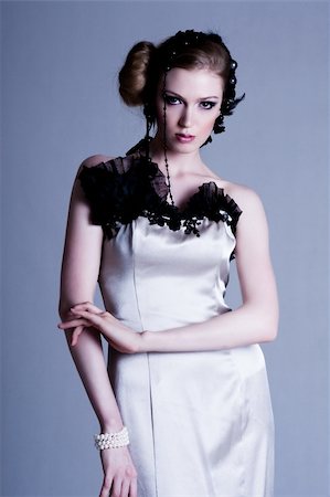 simsearch:400-04672927,k - Attractive young woman wearing an evening gown of black lace and white satin. Vertical shot. Foto de stock - Super Valor sin royalties y Suscripción, Código: 400-04672943