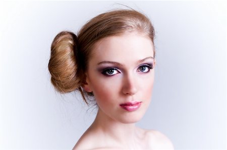 simsearch:400-04672946,k - Attractive young woman with her hair in a bun looks towards the camera. Horizontal shot. Stock Photo - Budget Royalty-Free & Subscription, Code: 400-04672952