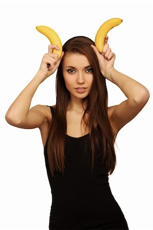 pretty women eating banana - The woman holds bananas on a head Photographie de stock - Aubaine LD & Abonnement, Code: 400-04673236