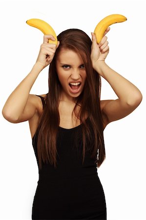 pretty women eating banana - The woman holds bananas on a head Photographie de stock - Aubaine LD & Abonnement, Code: 400-04673237