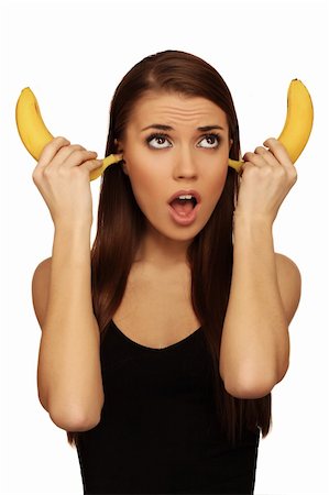 pretty women eating banana - The woman holds bananas on a head Photographie de stock - Aubaine LD & Abonnement, Code: 400-04673238